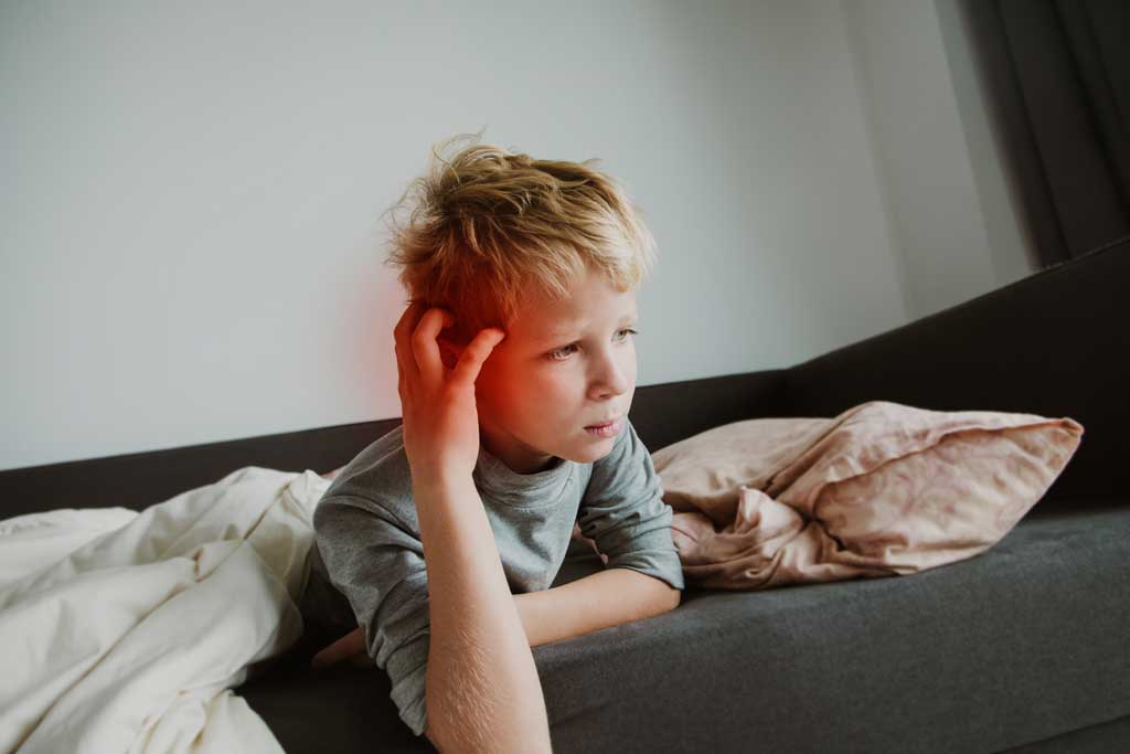 Boy-touching-his-ear-in-pain-and-needing-adenoidectomy