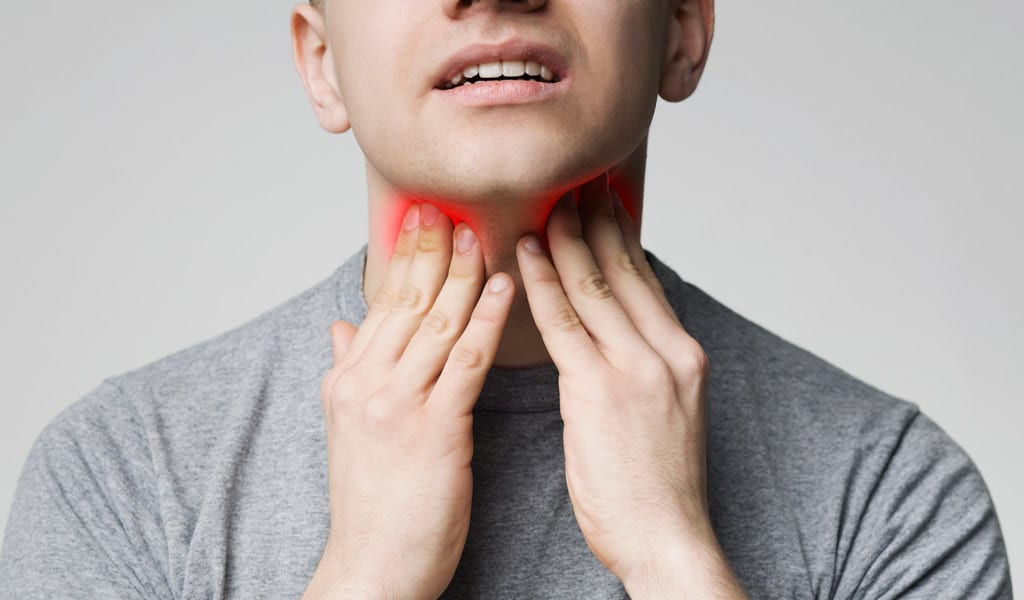 Man-touching-his-neck-in-pain-and-needing-tonsils-removal-in-Beverly-Hills