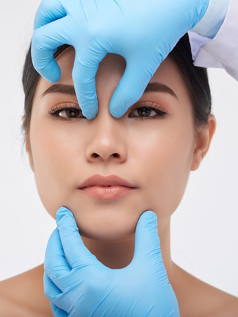 Surgeon-evaluating-a-woman’s-face-before-nasal-surgery-in-Beverly-Hills Surgeon-evaluating-a-woman’s-face-before-nasal-surgery-in-Beverly-Hills