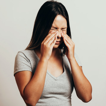 Woman-experiencing-pain-in-her-sinuses-and-needing-to-see-a-Beverly-Hills-ear,-nose,-and-throat-doctor Woman-experiencing-pain-in-her-sinuses-and-needing-to-see-a-Beverly-Hills-ear,-nose,-and-throat-doctor