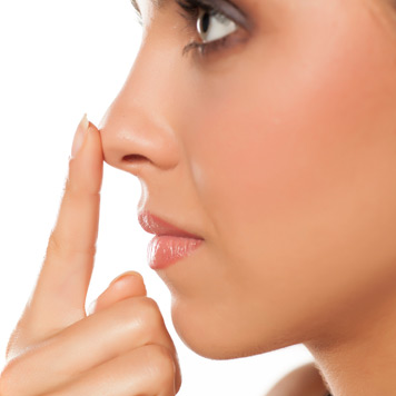 Woman-touching-her-nose,-showing-potential-results-of-nasal-surgery-in-Beverly-Hills Woman-touching-her-nose,-showing-potential-results-of-nasal-surgery-in-Beverly-Hills