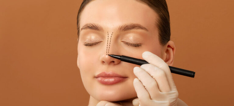 gloved-hand-marking-a-woman's-nose-with-a-pencil