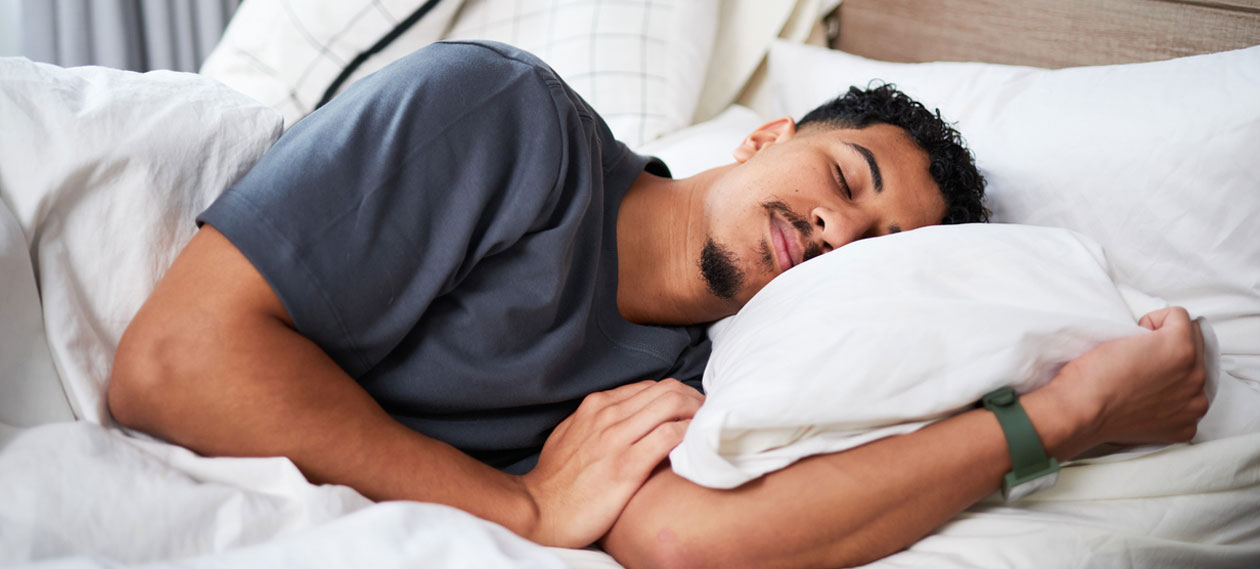 man-asleep-on-his-side-in-bed-with-his-mouth-open