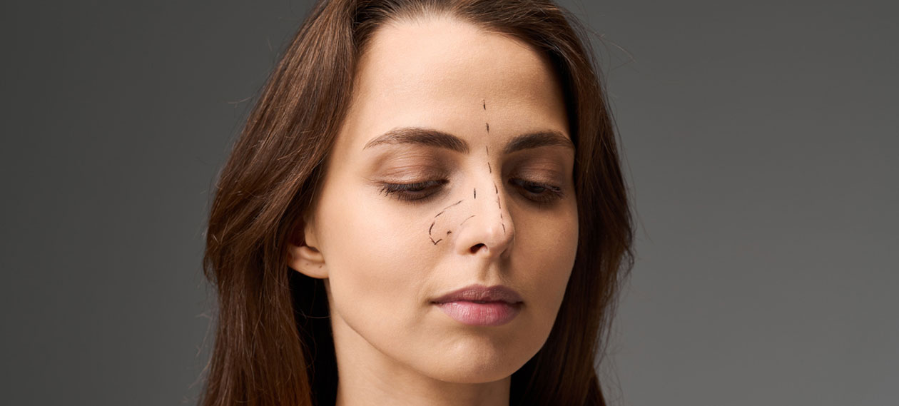 woman-with-her-eyes-closed-against-a-dark-gray-background